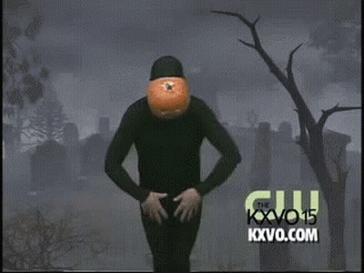 Person With Pumpkin Head Dancing In Cemetery GIF