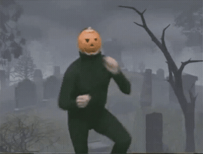 Person With Pumpkin On Head Dancing In Cemetery GIF