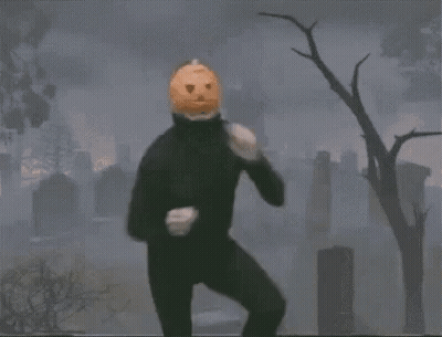 Person With Pumpkin On Head Dancing In Cemetery GIF