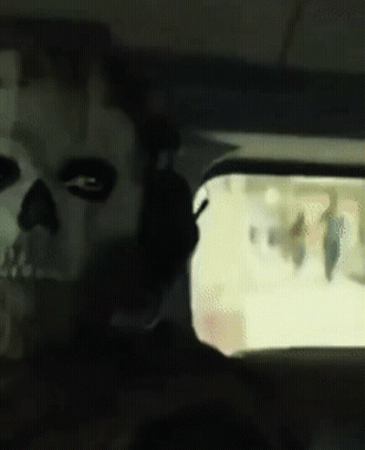 Person With Skull Face Looking Out Car Window GIF