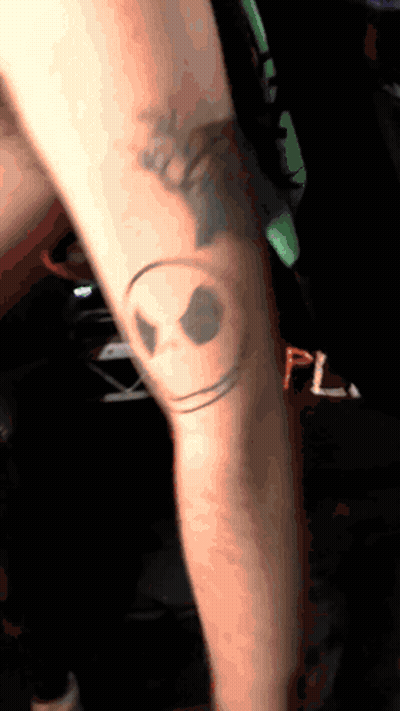 Person With Smiley Face Knee Tattoo GIF