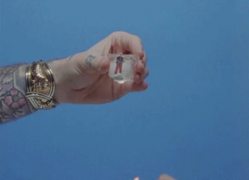Person With Tattoo Holding Lighter And Ice GIF