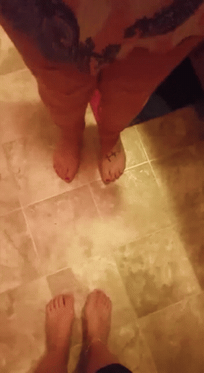 Person With Tattoo On Foot Next To Another Foot GIF