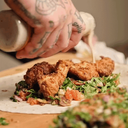 Person With Tattoo Pouring Sauce On Tortilla GIF
