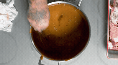 Person With Tattoo Stirring Pot GIF