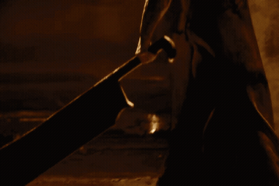 Person With Triangle On Back In Dark GIF