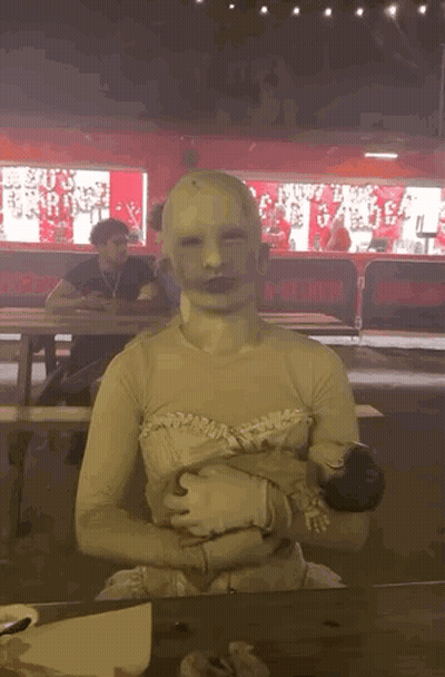 Person With White Mask Sitting At Table GIF