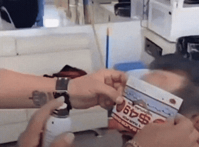 Person With Wrist Tattoo Holding Box Saying $49 GIF