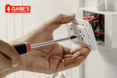 Person Working On Electrical Outlet With Gabe's Logo Background GIF