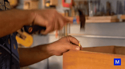 Person Working On Wood With Letter M GIF