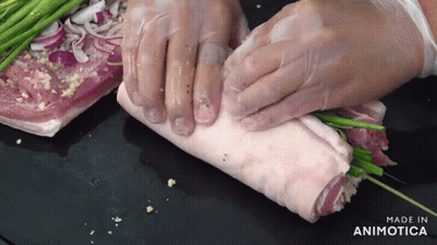 Person Wrapping Meat With Green Onions Made In Animotica GIF
