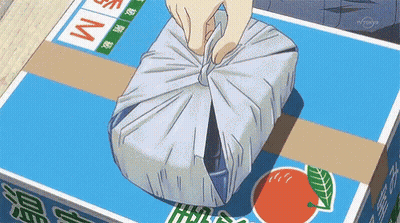 Person Wrapping Package In Blue Box Saying M GIF