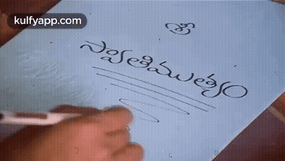 Person Writing In Foreign Language With Pen GIF