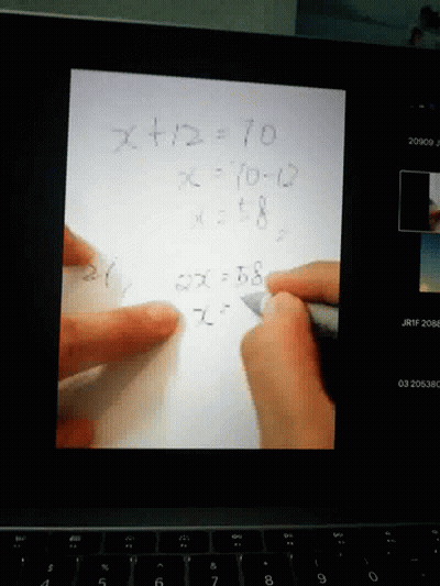 Person Writing Math Problem GIF