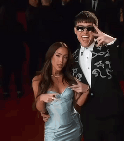 Peso Pluma And Nicki Nicole Posing On Camera GIF