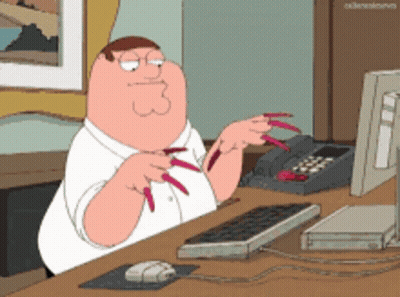 Peter Griffin From Family Guy Is Sitting At A Desk With A Keyboard And Mouse GIF
