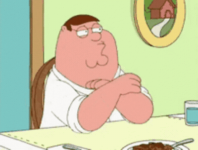 Peter Griffin From Family Guy Is Sitting At A Table GIF