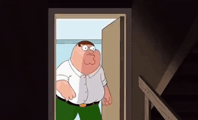 Peter Griffin From Family Guy Is Standing In A Doorway Looking Out . GIF