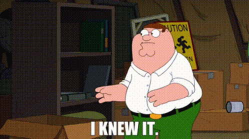 Peter Griffin From Family Guy Is Standing In A Room With Boxes And A Sign That Says Caution . GIF