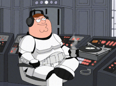 Peter Griffin Is Wearing Headphones And Holding A Cup Of Coffee While Sitting In Front Of A Record Player GIF