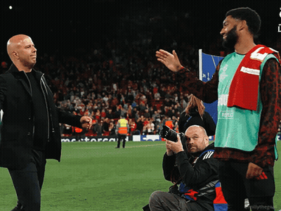 Photographer Taking Picture Of Two Men Shaking Hands On Field GIF