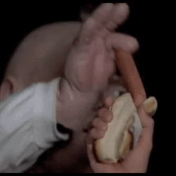 Picked Brown Hotdog By Fingers GIF