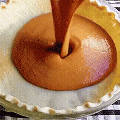 Pie Crust Being Filled With Caramel Sauce GIF