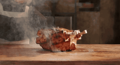 Piece Of Meat Cooking On Wooden Cutting Board With Smoke GIF