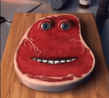 Piece Of Meat With Face On Cutting Board GIF