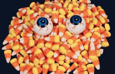 Pile Of Candy Corn With Two Eyeballs GIF