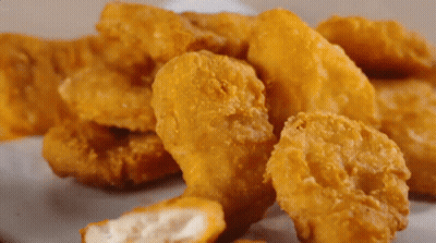 Pile Of Chicken Nuggets With Bite GIF
