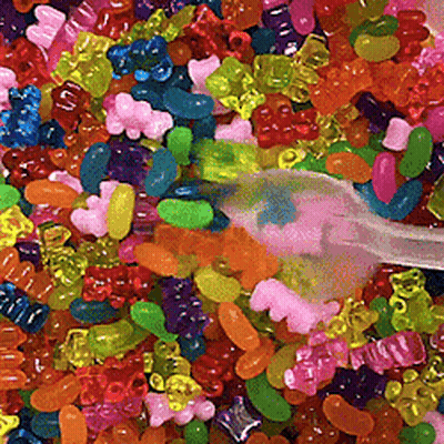 Pile Of Gummy Bears With Toothbrush GIF