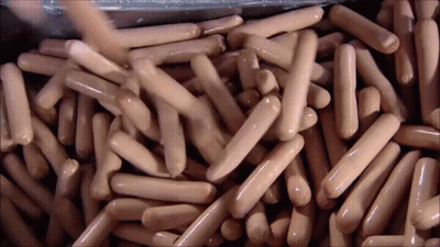Pile Of Hot Dogs Poured Into Container GIF