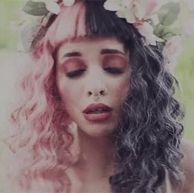 Pink-And-Black-Haired Woman With Flower Crown And Nose Ring GIF