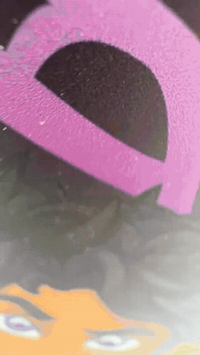 Pink and Black Item With Face