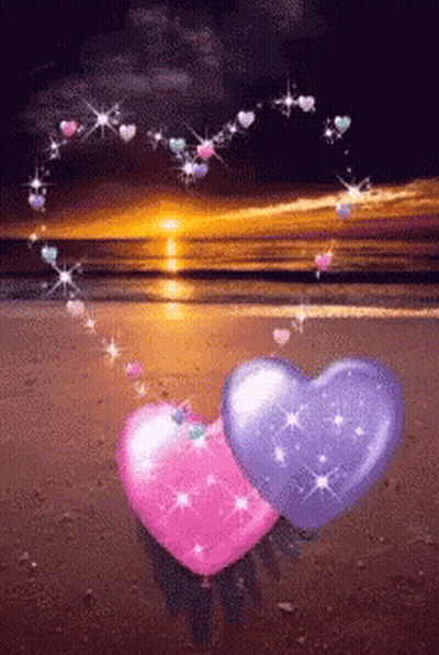 Pink And Purple Hearts On A Beach With Hearts Coming Out Of Them GIF