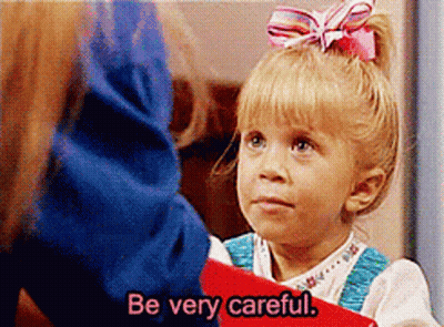 Pink-Bow Girl Holds Red Book Says Be Careful GIF