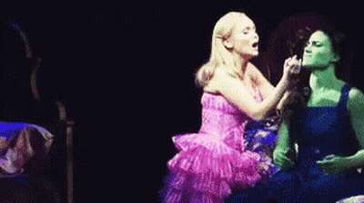 Pink Dress Woman Next To Blue Dress Woman GIF