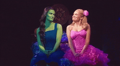 Pink Dress Woman Next To Blue Dress Woman GIF
