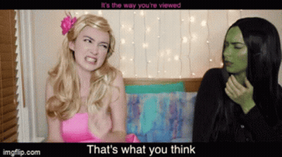 Pink Dress Woman Talking To Green Woman GIF