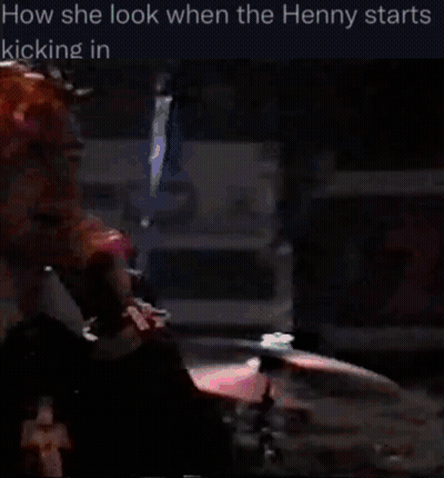 Pink-Haired Man At Microphone In Dark Room GIF