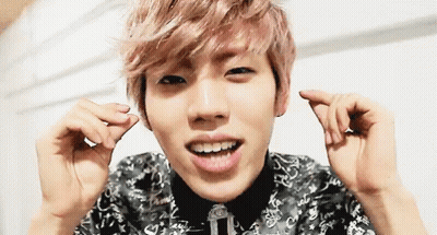 Pink-Haired Man Making Heart Shape And Smiling GIF