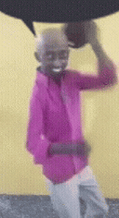 Pink Shirt Man Holding Basketball Over Head Smiling GIF