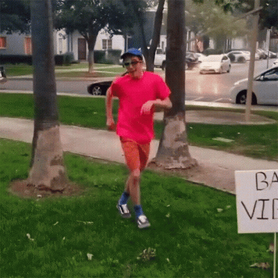 Pink Shirt Man Running By Ba Vi Sign GIF