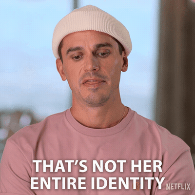 Pink-Shirt White-Hat Man That's Not Her Entire Identity GIF