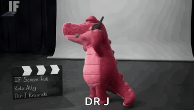Pink Stuffed Alligator In Front Of Clapper Board GIF