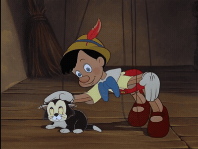 Pinocchio Playing With Black And White Cat GIF