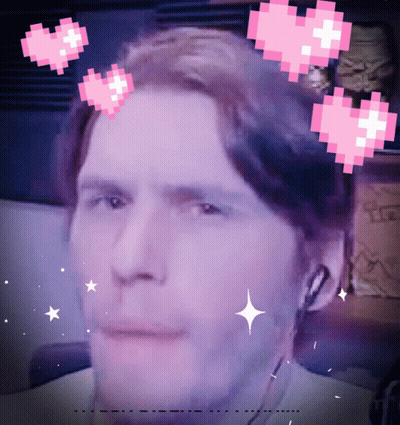 Pixelated Man With Hearts Around Head GIF