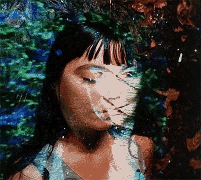 Pixelated Woman Face Surrounded By Trees GIF