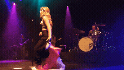 Pixelated Woman On Stage With Drum Set GIF